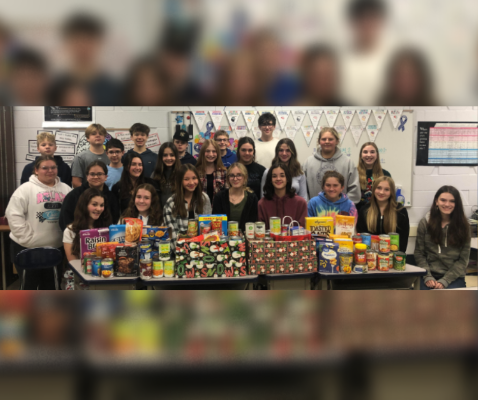 Students stand in front of cans