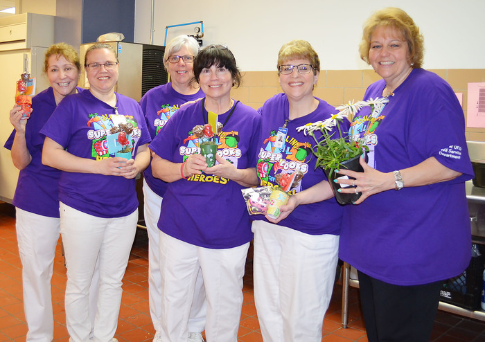 Food service workers hold gifts given to the during Lunch Hero Day.