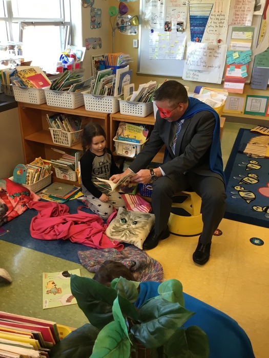 Dr. Jeffrey Rabey (aka Reading Man) reading with kindergarten students  